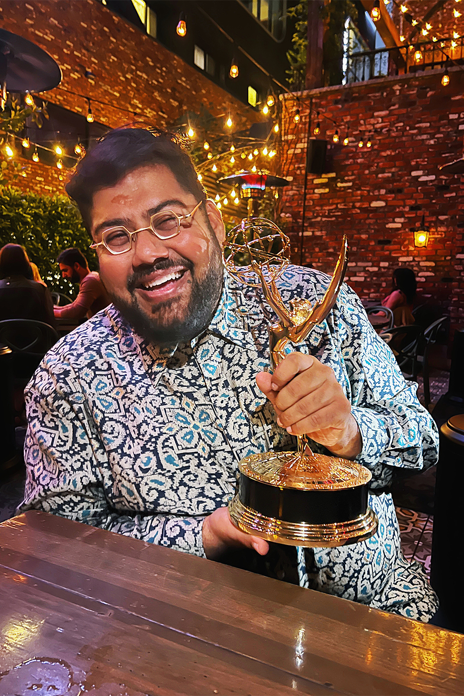 Shams Ahmed holding Emmy Award