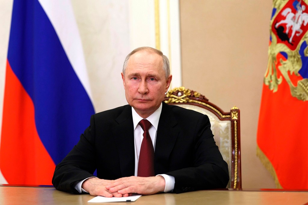 President Valdimir PUtin sitting at a desk