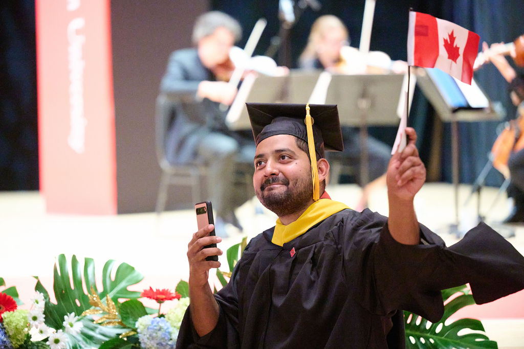 A graduate taking pictures.