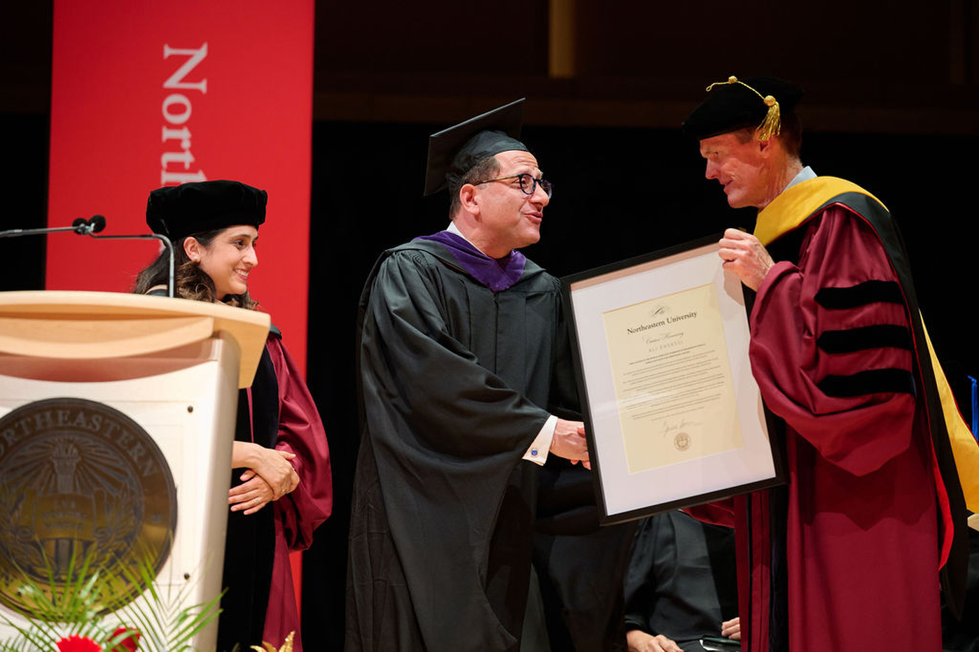 A speaker receives an award at Northeastern's Toronto convocation.