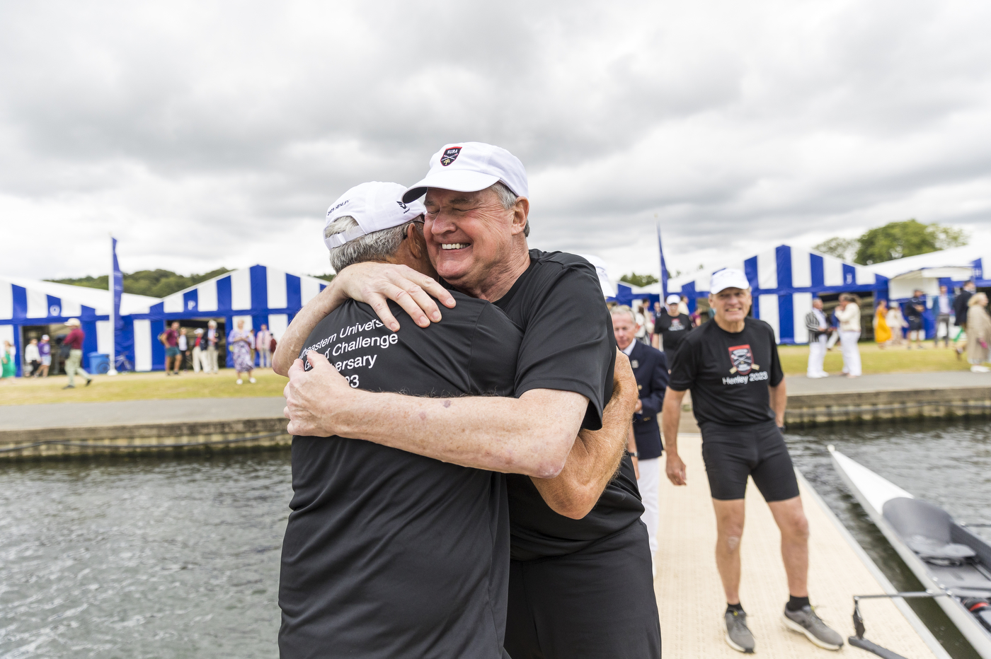members of the 1973 crew team hugging each other