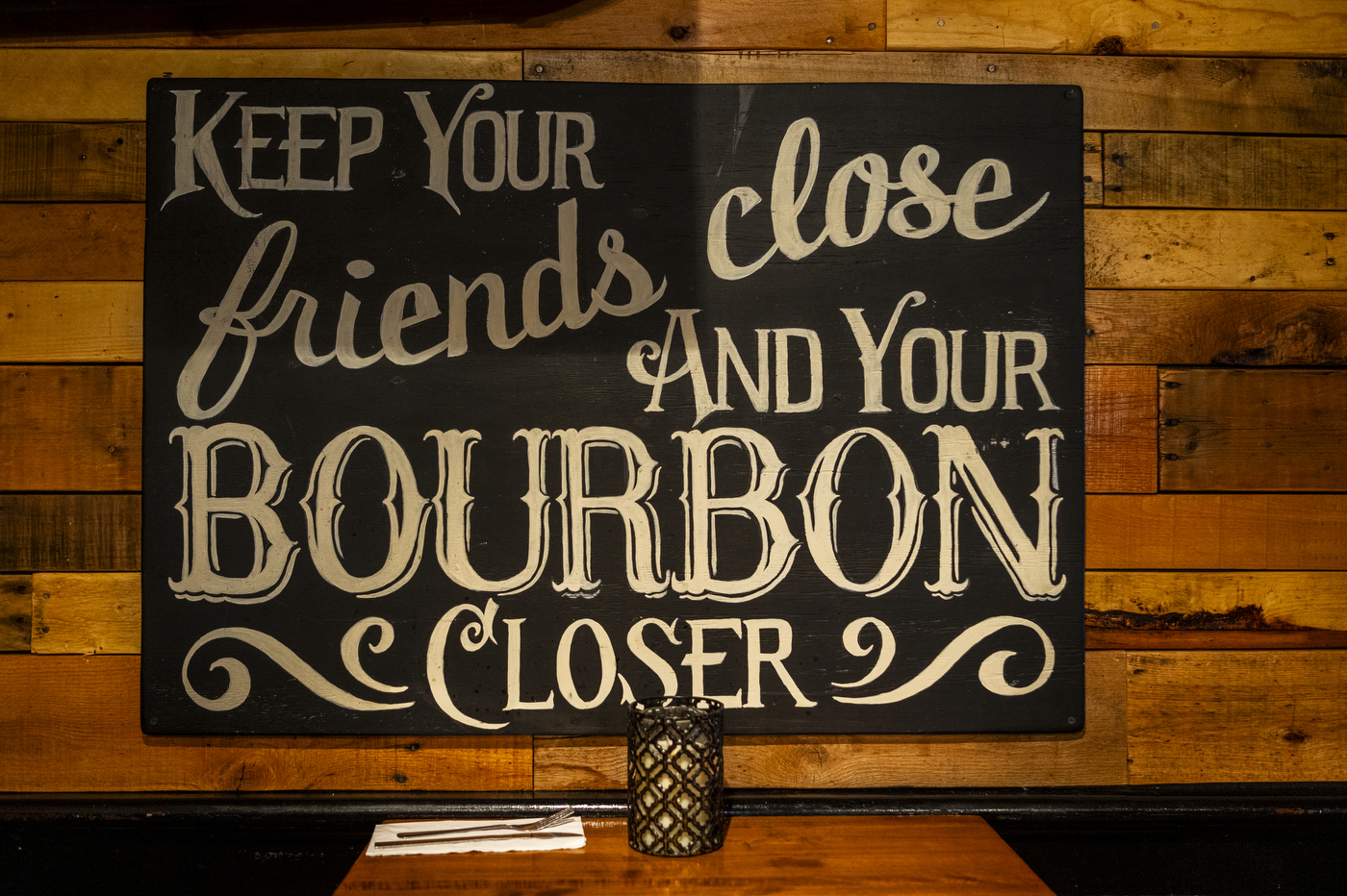 sign that says "keep your friends close and your bourbon closer"