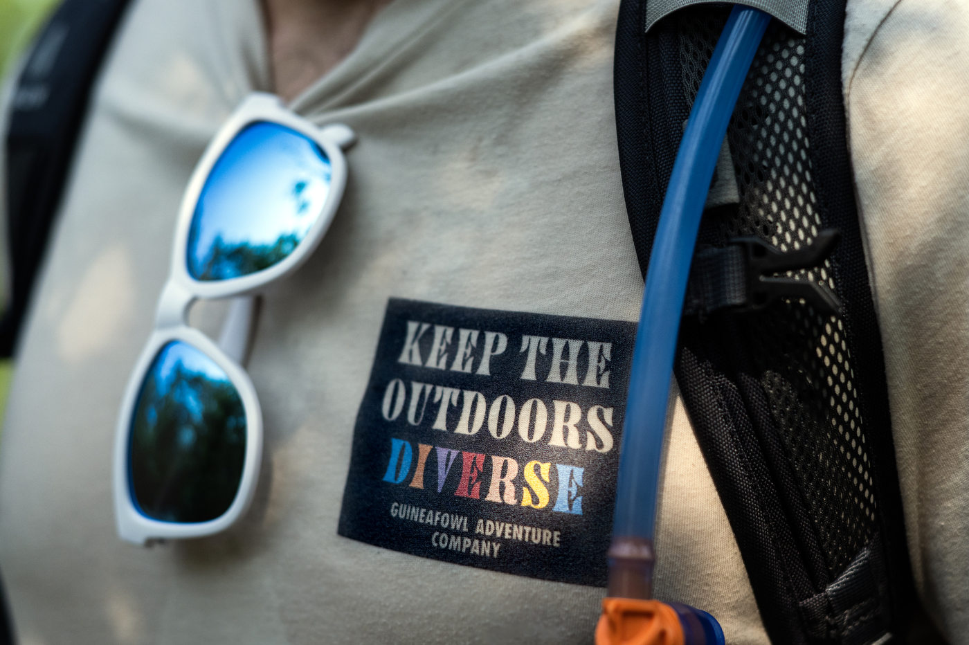 David Fatula wearing a Guineafowl Adventure Company shirt that says "Keep the outdoors diverse" in all caps on it