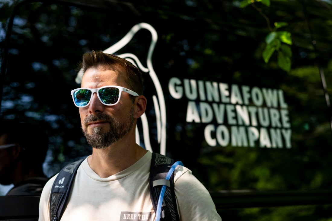David Fatula posing in front of a Guineafowl Adventure Company branded truck