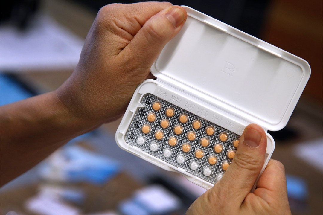 Dr Sophia Yen holding a one month prescription pack of birth control pills