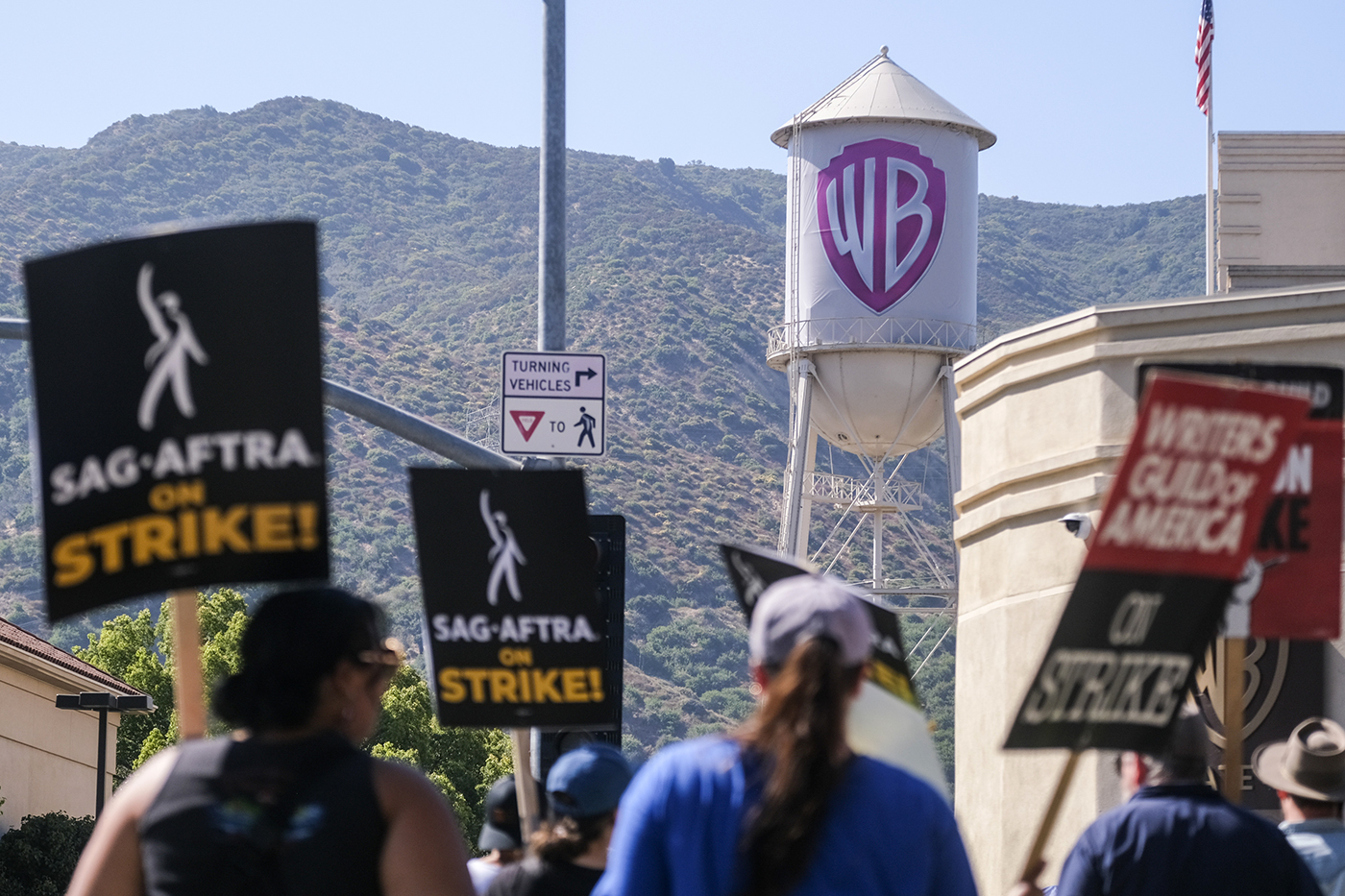 striking writers and actors outside Warner Bros Studios in California
