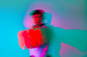 Brian Meagher, dressed in his taekwondo clothes, punches his fist forward.