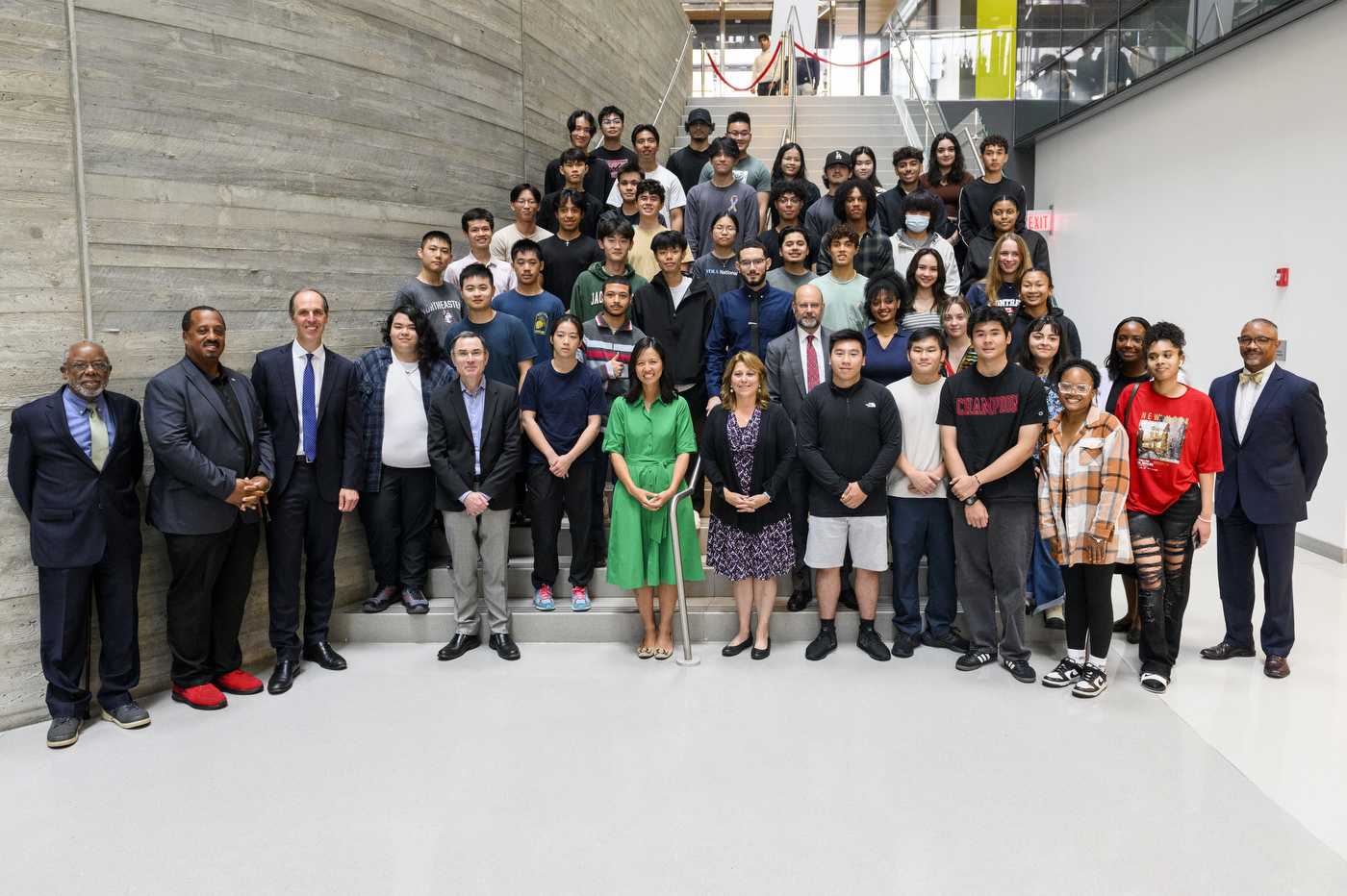 BPS students posing with Mayor Michelle Wu, Michael Armini, Ken Henderson, and other members of the Northeastern community