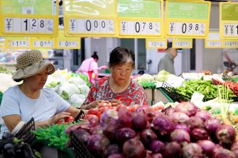 consumers buying vegetables at supermarket in China
