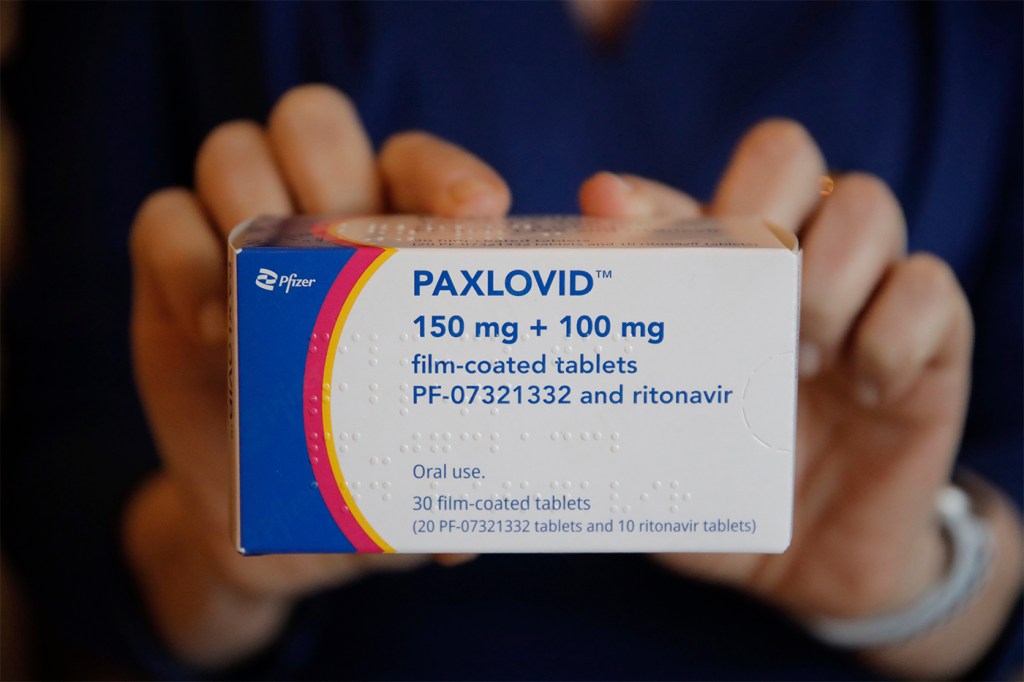person holding box of Paxlovid