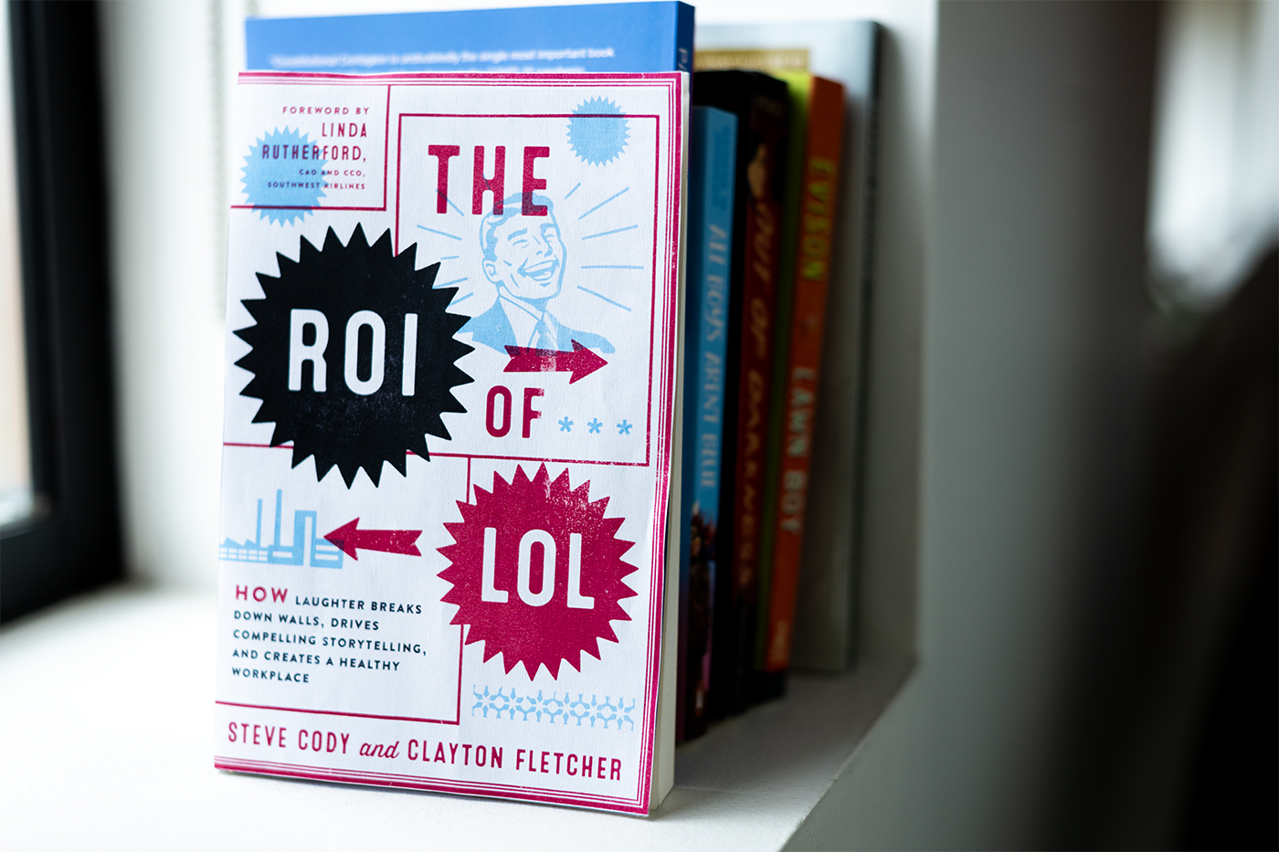 a copy of Steve Cody and Clayton Fletcher's book "The ROI of LOL" 