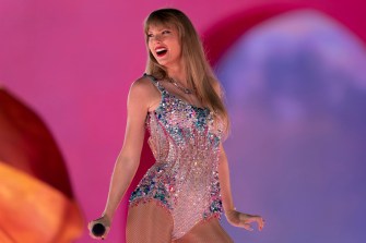 Taylor Swift performing during the Eras tour in a bedazzled bodysuit