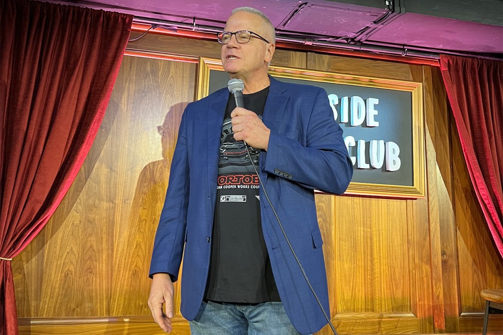 Steve Cody performing a stand up comedy routine on stage