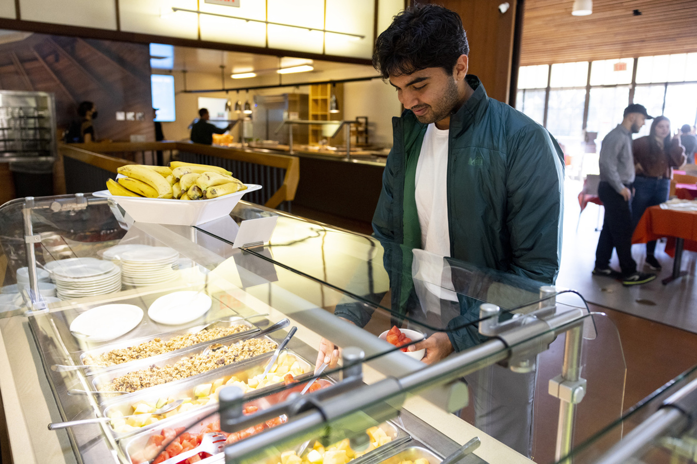 student looks at food options at Founders Commons