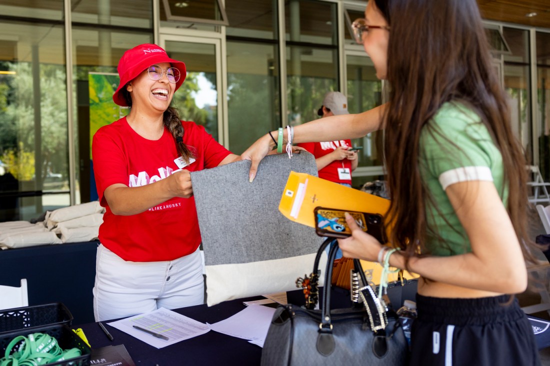 A student checking in with a volunteer during Mills College move-in week. 