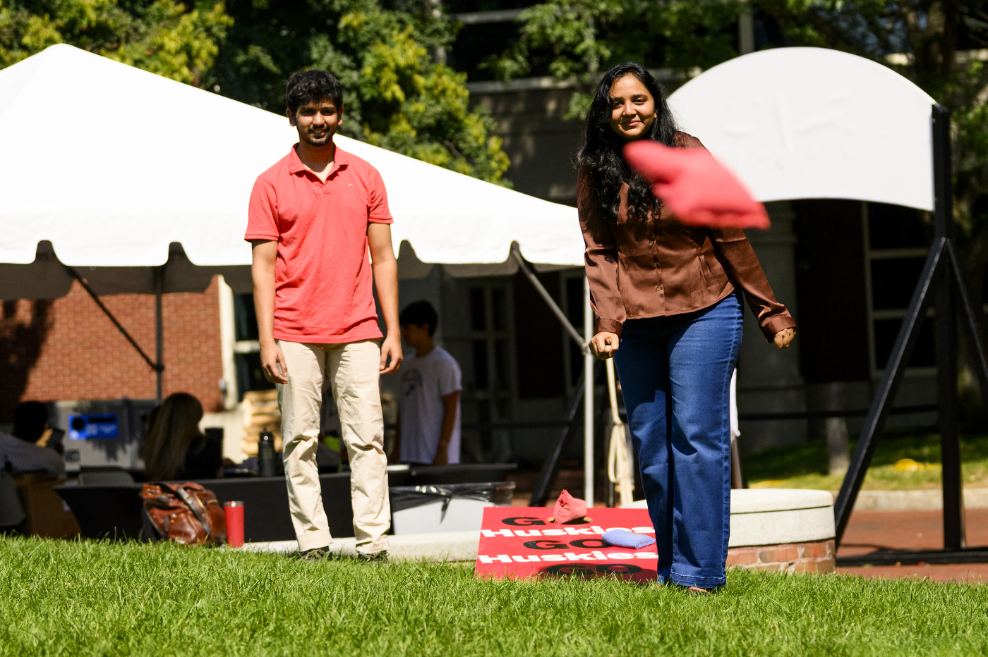 Two people play cornhole at Northeastern’s Welcome Week.