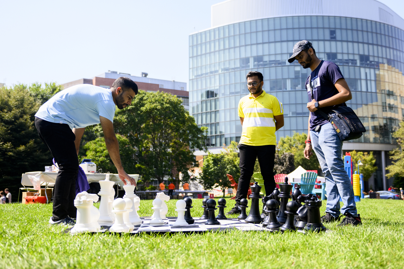 Three people play chess at Northeastern’s Welcome Week.