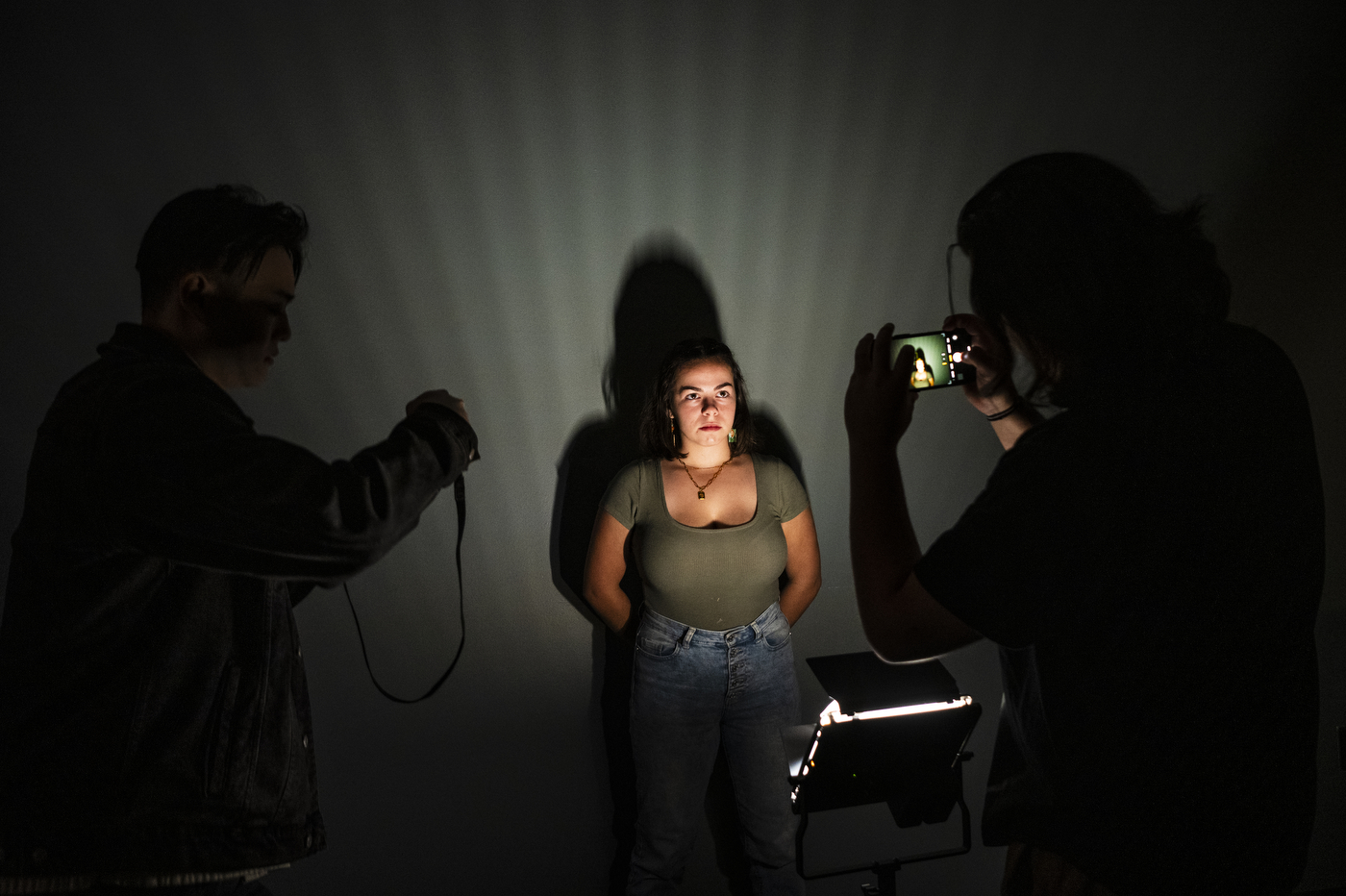 Krista Brochu posing as her classmates test out different lighting.