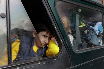 Ethnic Armenian boy looks out the window of a car.