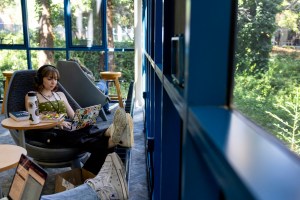 A student sits next to a window while studying.