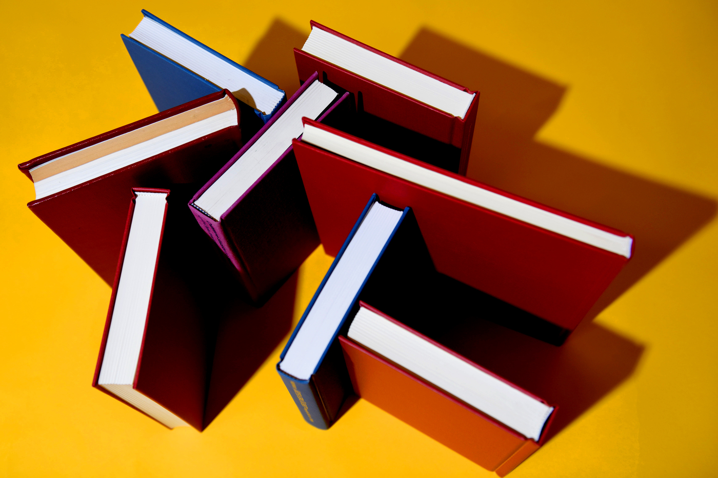books stacked on a yellow background