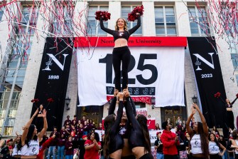 Cheerleaders outside of Ell Hall for Northeastern's 125th Birthday celebration.