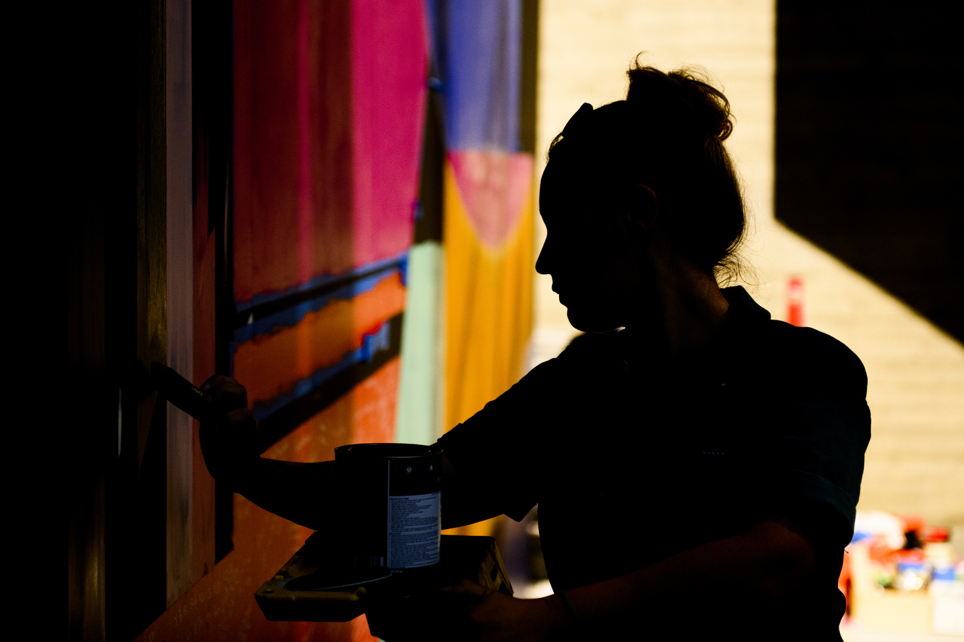 Artist painting the mural. 