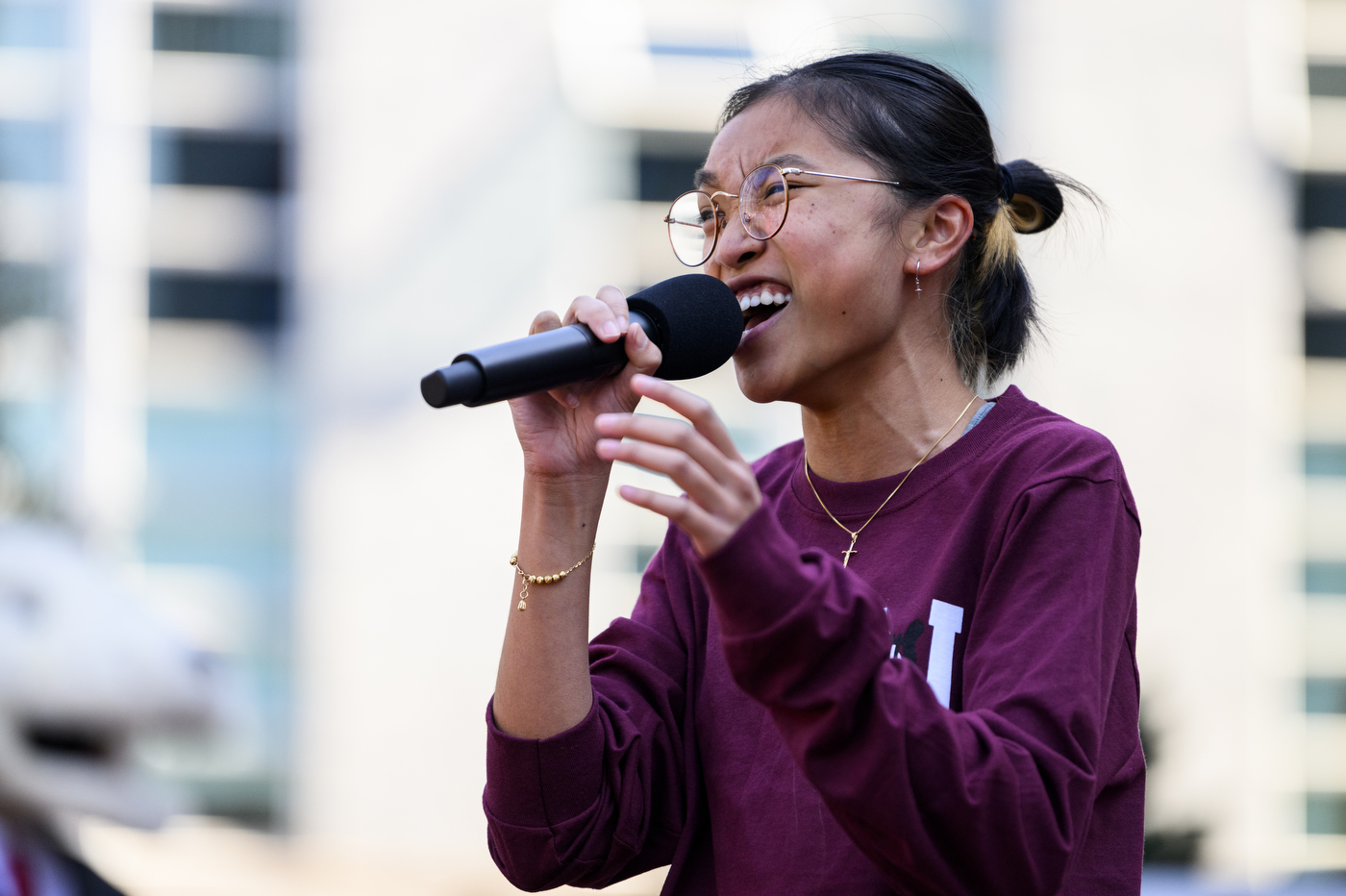 Northeastern student singing into microphone.