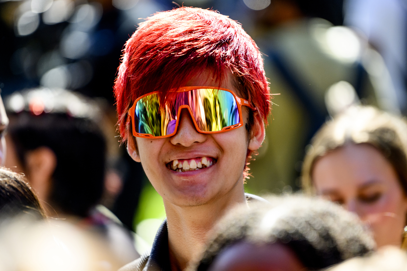 Northeastern student with red hair and red sunglasses posing for a photo.