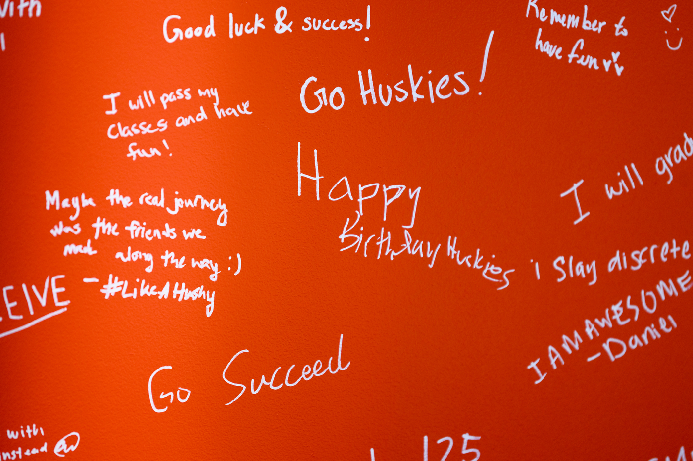 Messages written in white ink on a red background of the mural: Happy Birthday huskies, I am awesome, Go Succeed, Good luck and success!, Remember to have fun, Go Huskies!