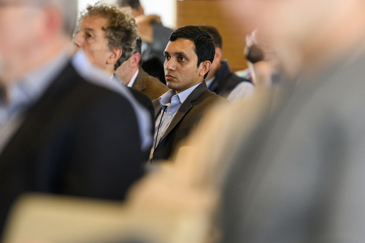 Audience members listening at the AI business conference.