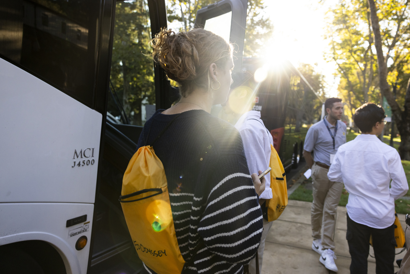 Students boarding charter buses outside at Northeastern's Oakland campus. 