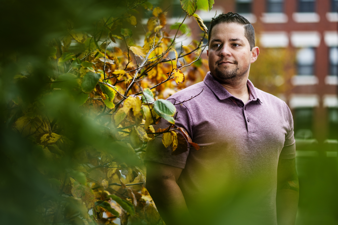 Headshot of Dennis Hernandez standing outside next to a tree.