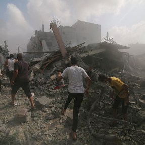Palestinians looking for survivors among rubble.