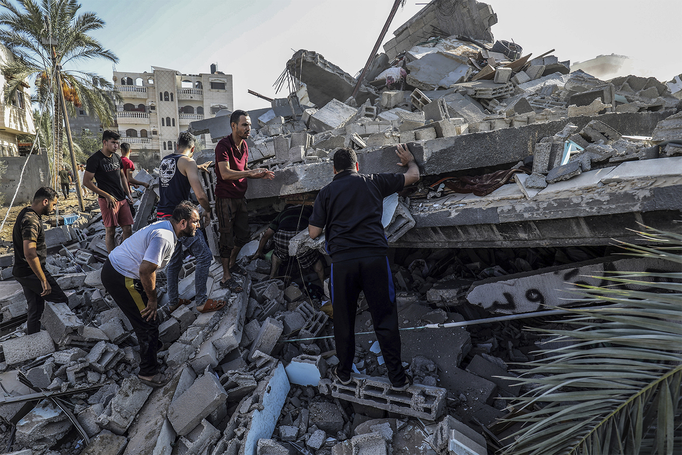 Palestinians searching for survivors among rubble.