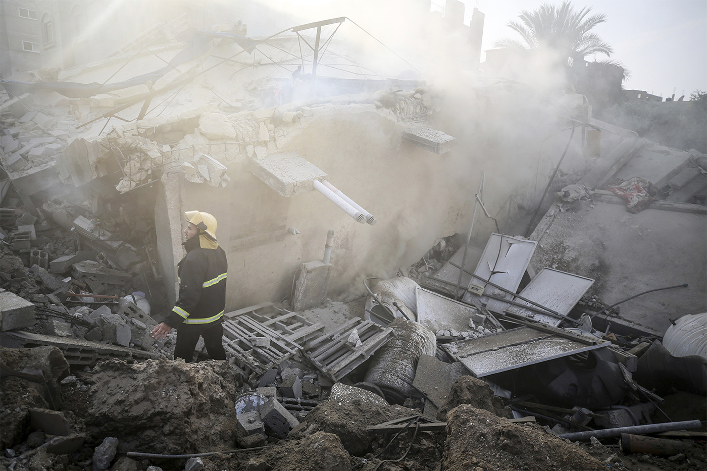 Men walking through rubble in Gaza.