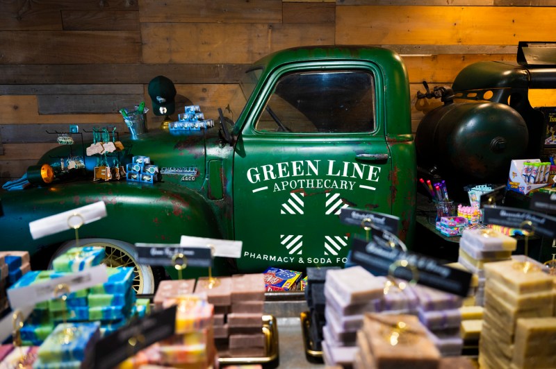 Vintage green truck with Green Line Apothecary's logo on it.