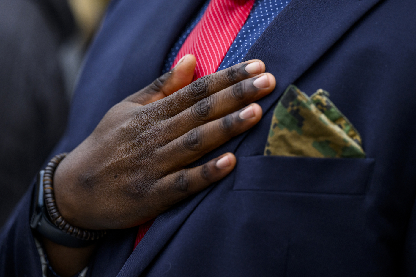 Person holding their hand over their heart at the Veterans Day ceremony.