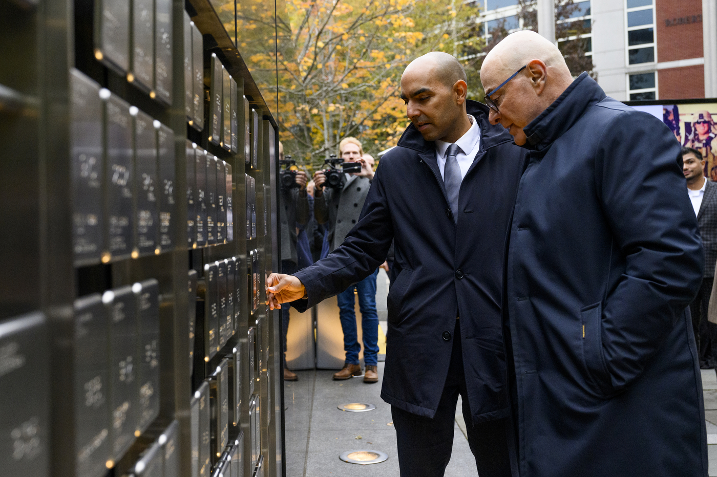 President Joseph E Aoun looking at the veteran plaques on the Boston campus.