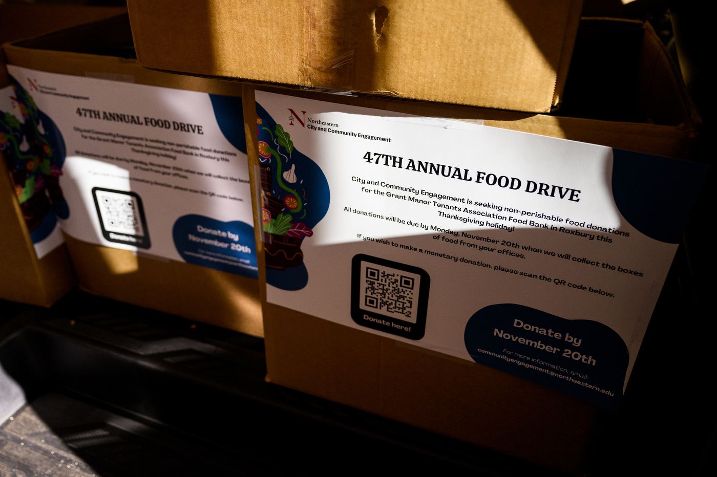 Boxes labeled with '47th Annual Food Drive' papers. 