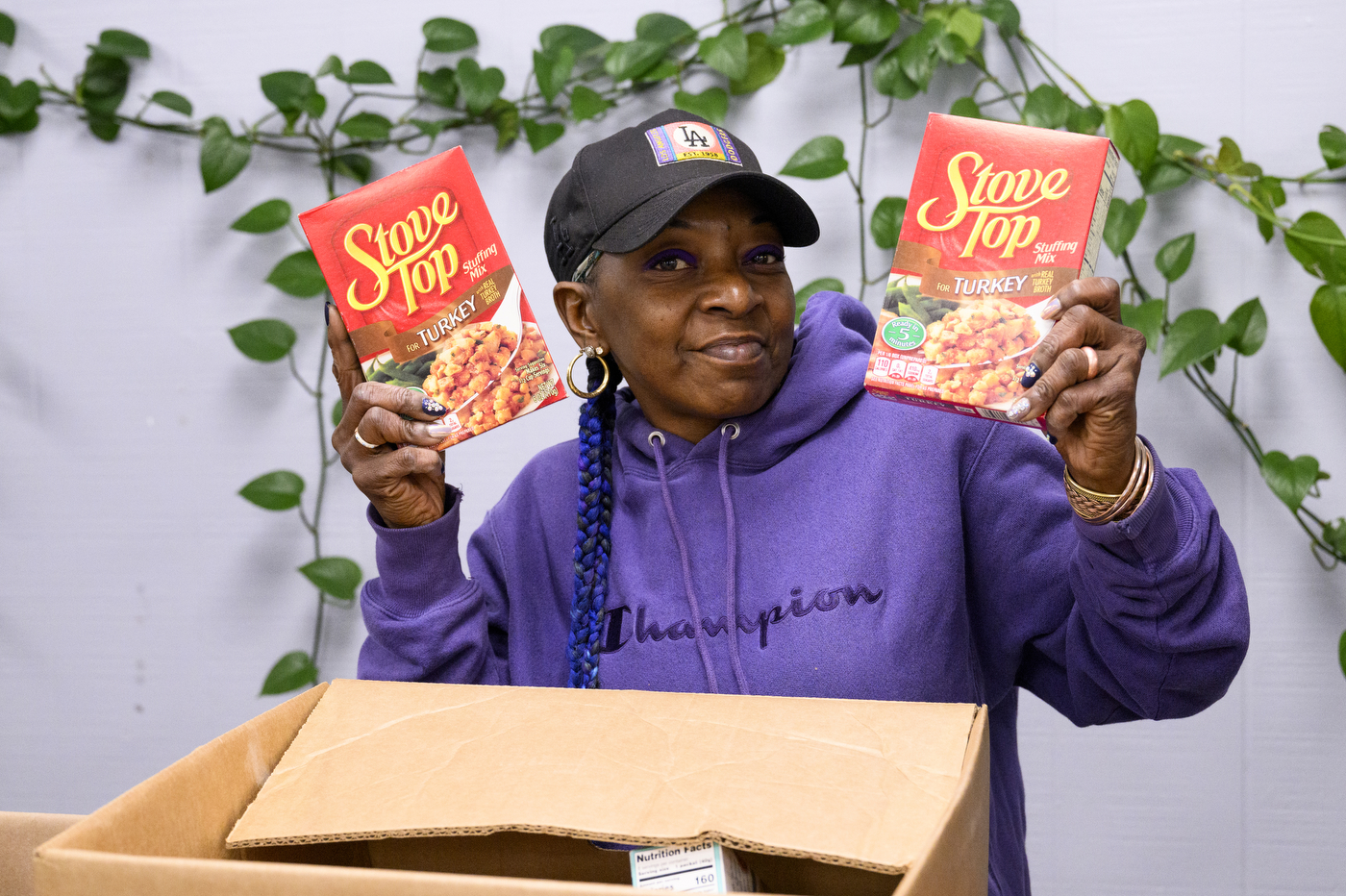 Person holding up two boxes of Stove Top Chicken stuffing mix. 