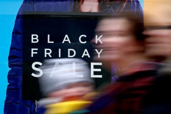 Blurred photo of a person walking with white overlaid text that says 'Black Friday Sale'.