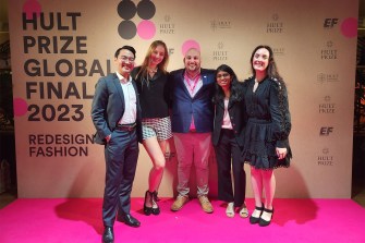 Izabella Pivo posing at the Hult Prize awards with four other people attending the ceremony.