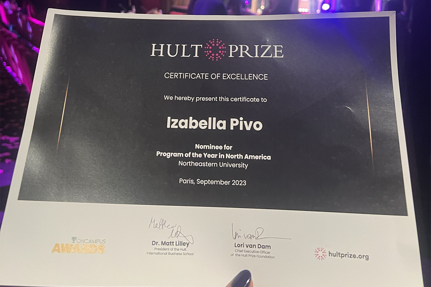 Paper certificate that reads Hult Prize Certificate of Excellence. We hereby present this certificate to Izabella Pivo, Nominee for Program of the Year in North America, Northeastern University.