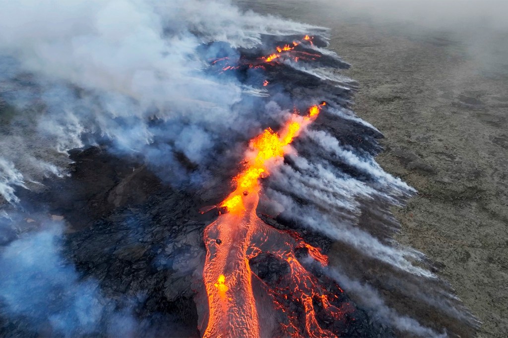 Orange lava emerging from a fissure in a volcano in Iceland.
