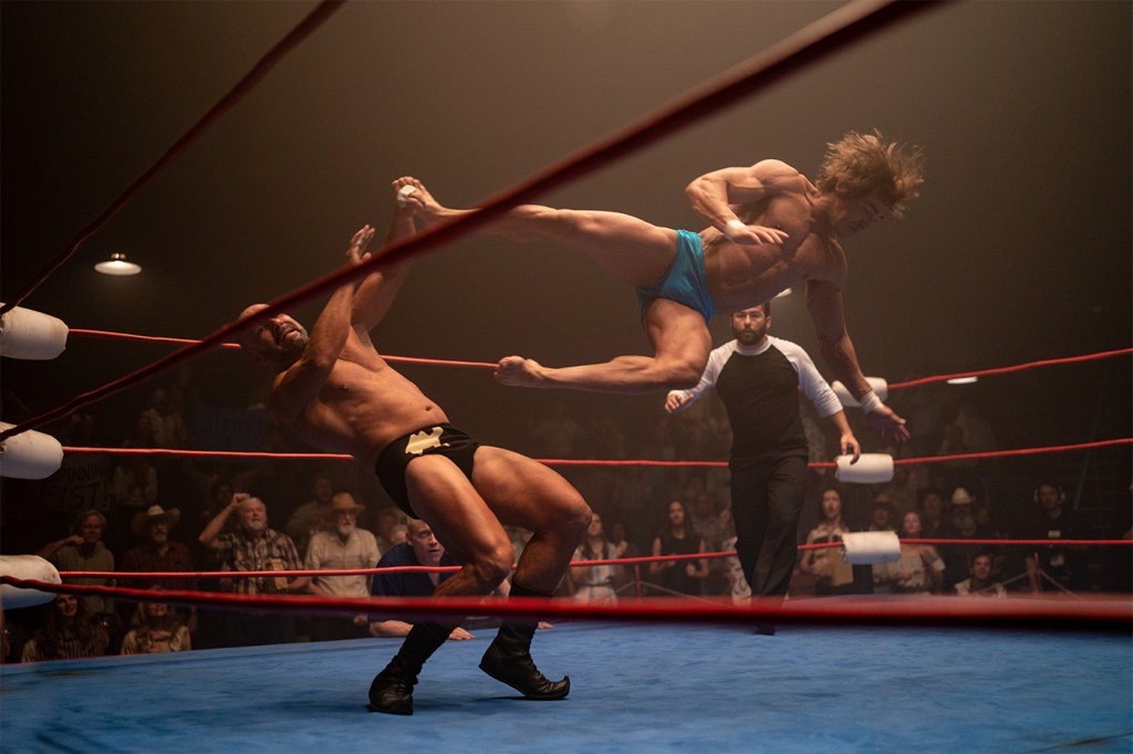 Screen capture of two wrestlers fighting in the wring in the 'Iron Claw' movie.