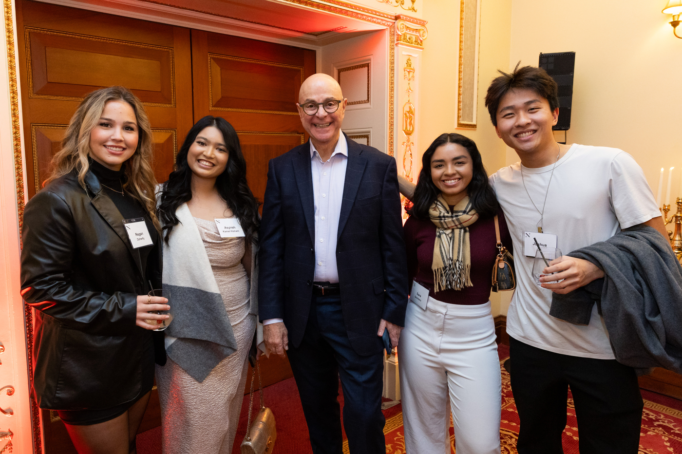 President Aoun poses for a picture with students at Northeastern's Thanksgiving celebration.