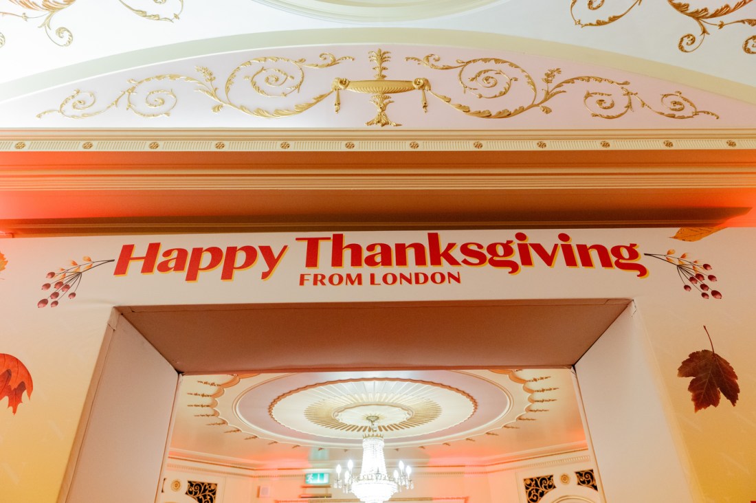 A doorway that says 'Happy Thanksgiving from London' over top of it. 