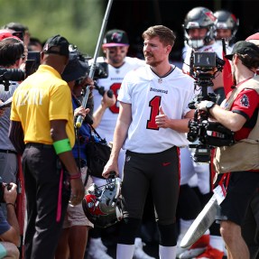 MrBeast wearing a football jersey leading the Tampa Bay Buccaneers out of the tunnel.