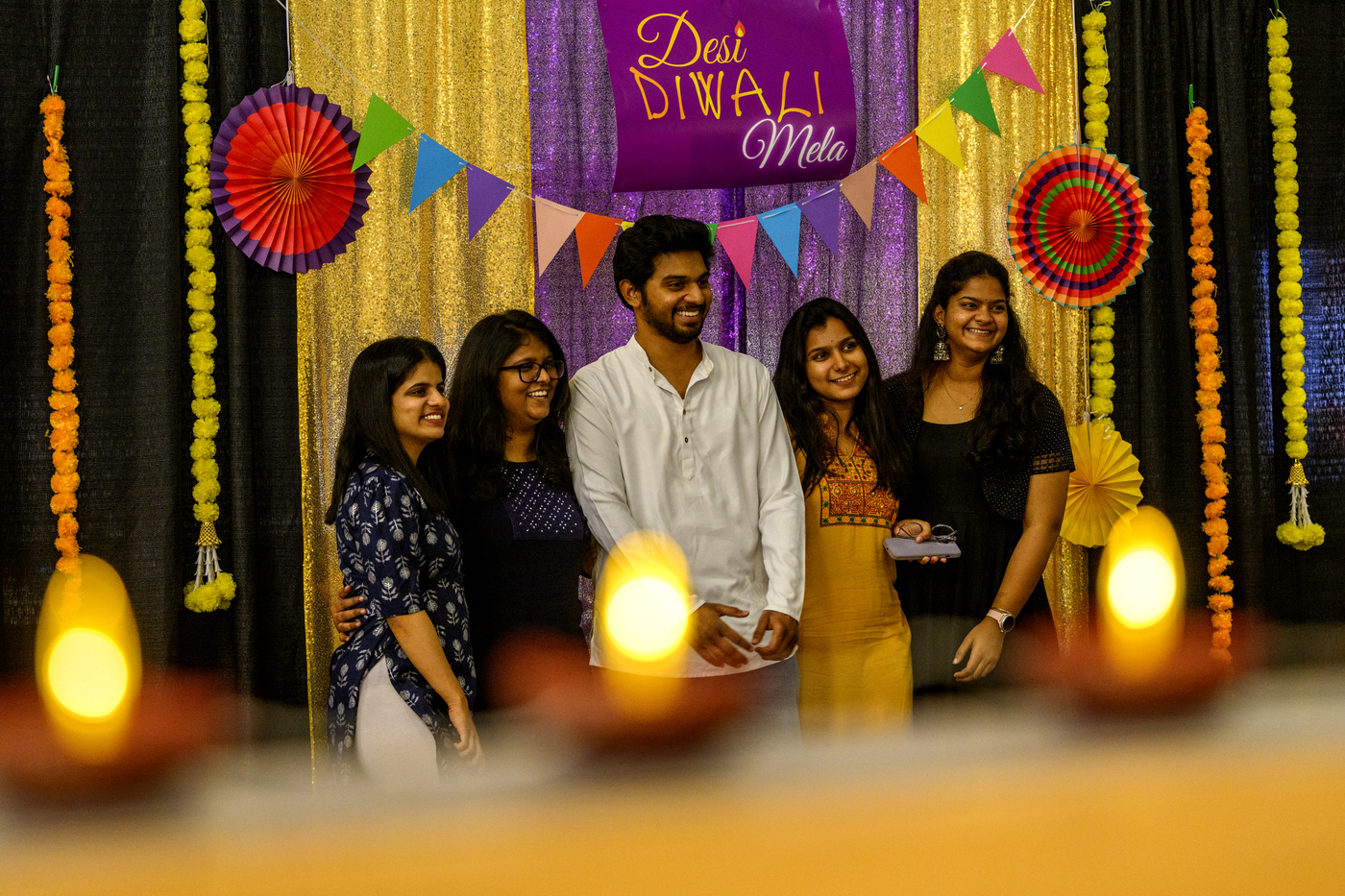 Group of people posing for a photo at a Diwali celebration on the Boston campus.